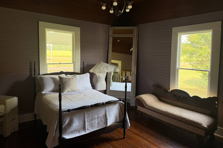 Vintage bridal suite bedroom with iron bed and antique fainting couch Old Fashioned Events Caledonia MS