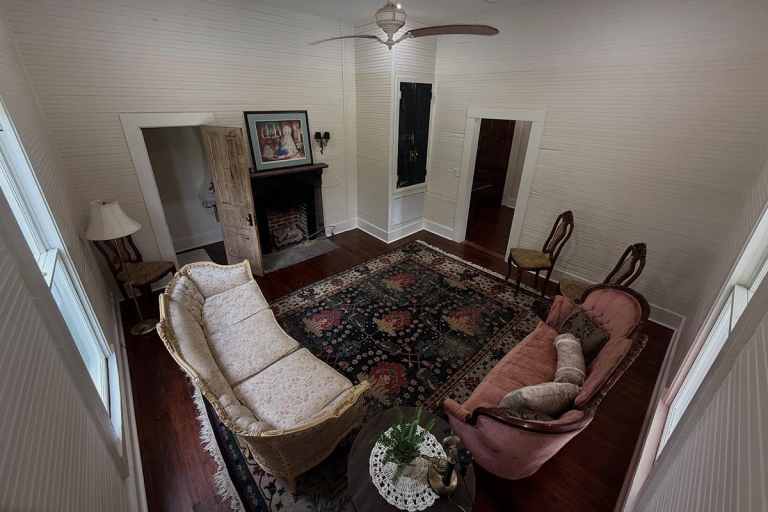 Vintage parlor interior with antique sofas and fireplace at Old Fashioned Events Caledonia MS